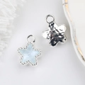 Macro detail of star charm with blue crystal inlay and silver hammered metal texture - Silver Base Sky Blue
