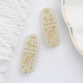 Detailed view of translucent Czech glass beads with gold Egyptian runes for DIY jewelry - White