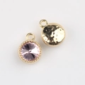 Detail of round pink crystal pendant with gold beaded edge and hammered metal back - Gold Base Purple Rhinestone