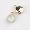 Detailed macro view of green crystal pendant with gold beaded edge and hammered metal back - Gold Base Pale Green