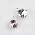 Macro detail of pink rhinestone pendant with beaded silver bezel and hammered back texture - Silver Base + Purple Rhinestone