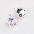 Macro detail of alloy round pendant featuring faceted crystal and hammered metal texture - Silver Base AB Color