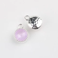 Detail of round alloy pendants with purple faceted crystal and hammered metal back textures - Silver Base Purple