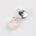 Detailed view of silver round bezel pendant with pink crystal and hammered metal texture - Silver Base Nude Pink