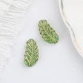 Detailed view of green Czech glass leaf beads with gold veined texture and scalloped edges - Light Green (00591501)