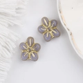 Detailed view of two purple Czech glass flower beads with gold leaf edges for DIY jewelry - Purple
