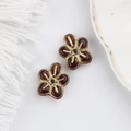 Detail of amber glass five-petal flower beads with gold gilding for DIY jewelry making - Tan