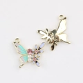 Detailed macro view of enamel butterfly pendant with pearls and crystals for DIY jewelry - Gold Base Blue Purple