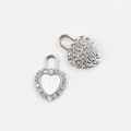 Detailed view of silver heart lock pendants with cubic zirconia inlay for DIY jewelry - Silver White
