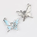Macro detail of enamel butterfly charm with pearls and sparkling crystals for DIY jewelry - Silver Base Blue White