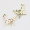 Detailed macro view of pink butterfly jewelry pendant with pearls and starry gold back - Gold Base Pink White