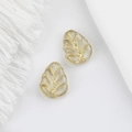 Macro view of two leaf-shaped glass beads with gold veins and vintage leaf vein detail - Clear