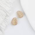 Macro detail of Czech glass leaf beads in soft pink with golden veins for DIY jewelry - Jade Pink