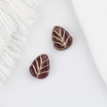 Detailed view of two dark red glass leaf beads with gold vein accents for DIY jewelry - Dark Purple