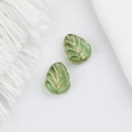 Detailed macro view of green glass leaf beads with gold gilded veins for DIY jewelry - Light Green