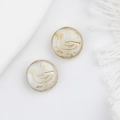 Close-up of duck-shaped Czech glass beads with gold accents on white tassel fabric - White