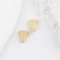 Macro shot of vintage Czech glass trumpet flower beads with hand-painted gold details - White