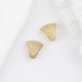 Macro detail of hand-painted golden flower glass beads with vintage bell-shaped design - Clear