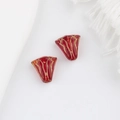 Macro detail of red Czech glass flower beads with hand-painted gold retro texture - Transparent Red