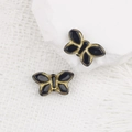 Dettaglio macro di perle a farfalla ceche vintage con smalto nero e finiture in oro - Nero (00631101)