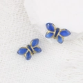 Dettaglio di perline a farfalla in vetro blu con accenti dorati per gioielli DIY - Blu (00631601)