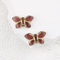 Dettaglio macro di perle a farfalla in vetro viola 19x11mm con dettagli in oro su pietra - Viola Scuro (00632101)