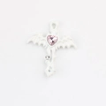 Close-up of white gothic cross pendant with pink heart crystal and bat wing details - White Pink