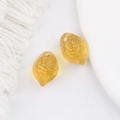 Detailed macro view of yellow lemon-shaped Czech glass beads for DIY jewelry making - Transparent Yellow