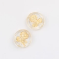 Macro shot of Czech glass beads with hand-painted gold compass sunflower patterns - Clear