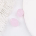 Macro detail of two light pink matte resin beads for DIY jewelry making and crafting - Pink