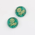 Detailed macro of green glass beads with gold sunflower patterns for DIY jewelry making - Transparent Green