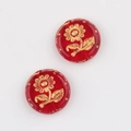 Close-up of red Czech glass sunflower beads with gold hand-painted details and glitter - Transparent Red