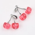 Detailed view of two cherry charms with translucent pink resin, glitter, and silver leaves - Silver Rose Red