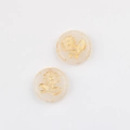 Detailed macro view of two cream Czech glass beads with gold sunflower pattern for DIY jewelry - Jade Color