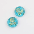 Close-up of blue Czech glass beads with gold sunflower pattern and green leaf detail - Transparent Sky Blue