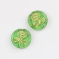 Detailed macro of green translucent glass beads with gold sunflower engraving for DIY - Transparent Grass Green