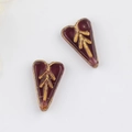 Detailed view of burgundy Czech glass heart beads with vintage gold leaf pattern for DIY jewelry - Transparent Dark Purple