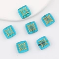 Detailed macro view of square translucent blue glass beads with gold firework pattern - Transparent Blue
