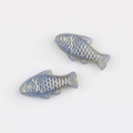 Macro detail of two light blue glass fish beads with hand-painted gold leaf scales - Lavender