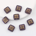 Macro view of purple square glass beads with hand-painted gold starburst patterns for DIY - Amethyst