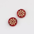Detailed macro view of two red glass beads with golden geometric floral pattern for DIY jewelry - Transparent Red (00670501)