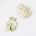 Detail of Monet Garden pendant with enamel inlay and textured gold star pattern back - Oval Gold White
