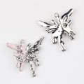 Close-up of alloy butterfly pendants with pink enamel and sparkling heart-shaped gemstones - Silver / Pink
