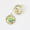 Detailed macro view showing front and back of Monet garden style enamel pearl pendant - Round Gold Green