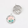 Macro detail of enamel flower pendants with small pearl in silver-tone metal finish - Round Silver Pink