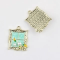 Detailed view of alloy window-frame pendant with green enamel and pearl inlay charms - Square Gold Blue Plate