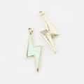 Macro detail of lightning charms with light green marble texture and golden metal star patterns - Gold Green