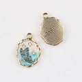 Detail of blue butterfly pendant with oil drip finish and small white zircons - Gold Base Blue Butterfly
