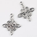 Macro view of silver Celtic knot charms with intricate textures and top hanging rings - Celtic Knot / Silver