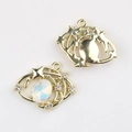 Detail of gold-plated eye pendant showing white opal inlay and hollow metal back structure - Gold White Zirconia